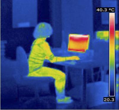 Thermal energy will flow from the person to the desk